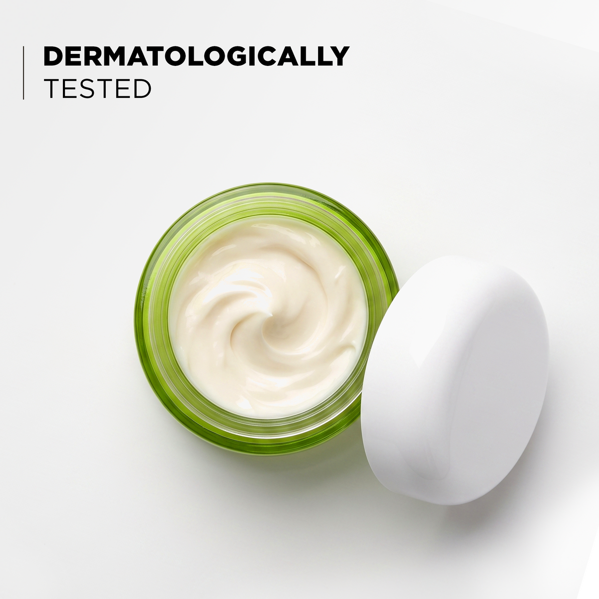 Open jar showing the cream texture, dermatologically tested